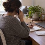 Pennsylvania Electricity Supplier Complaints: How To Document, File, And Resolve A Billing Dispute A Person Taking Notes On A Phone Call With Electricity Bills On The Desk